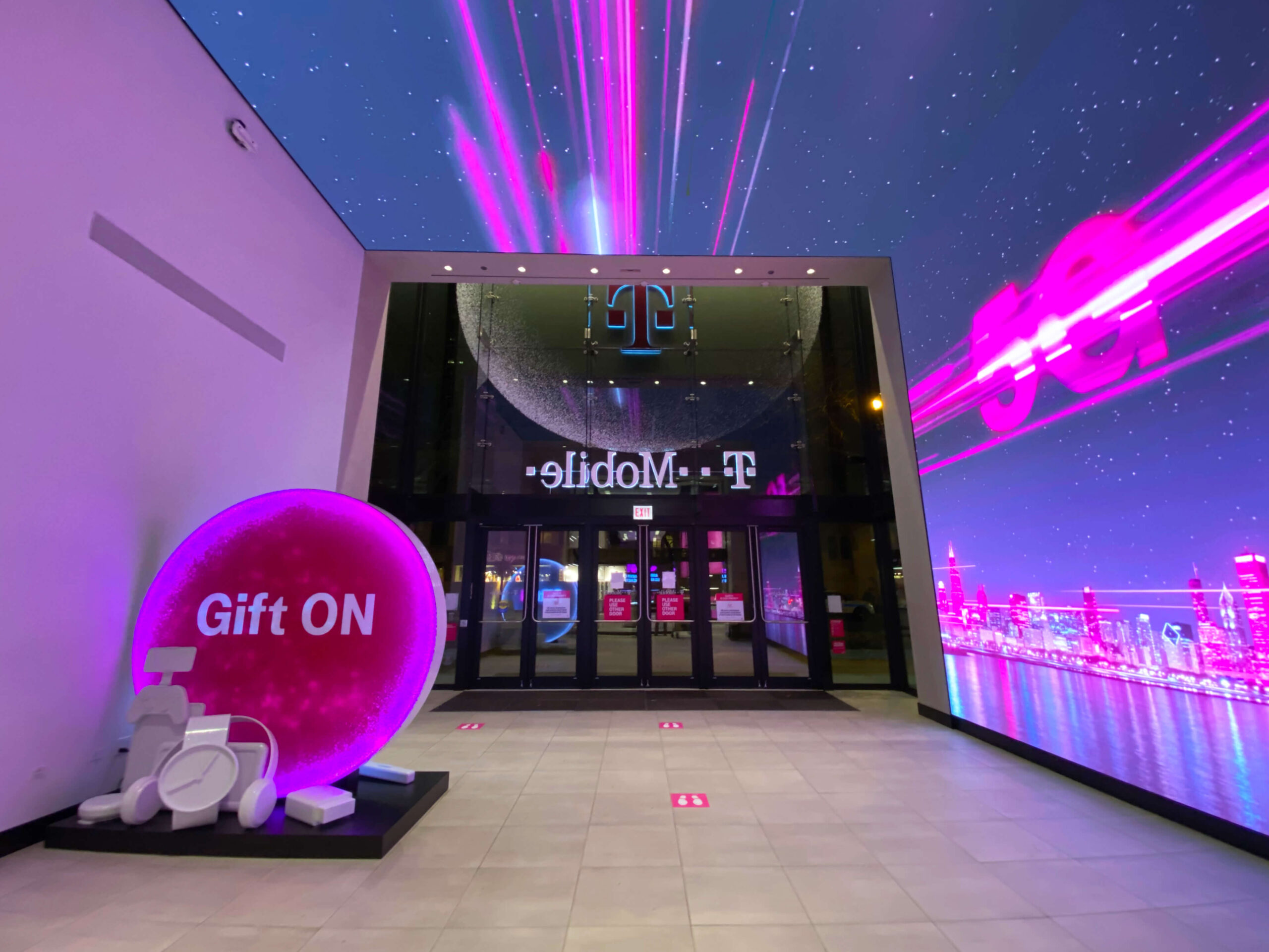 Photo of T-Mobile Snowglobe white ink graphics for 2020 Holiday Campaign, completed by SuperGraphics.
