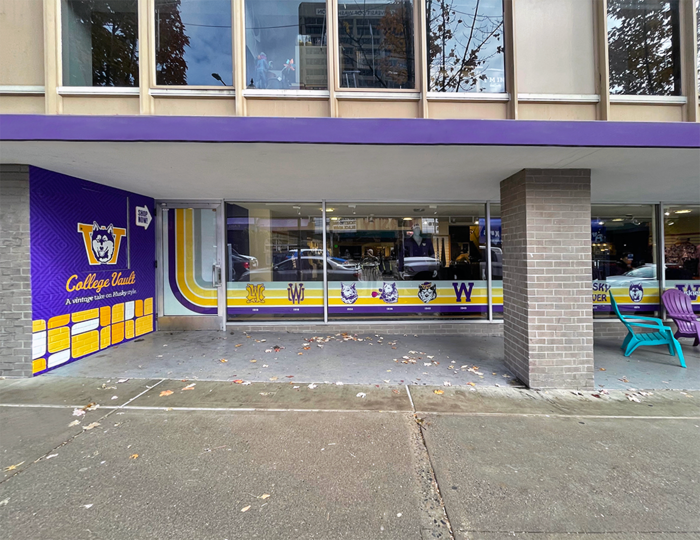 Outside image of University of Washington's bookstore that showcases wall graphic and window graphics with school crests throughout it's history.