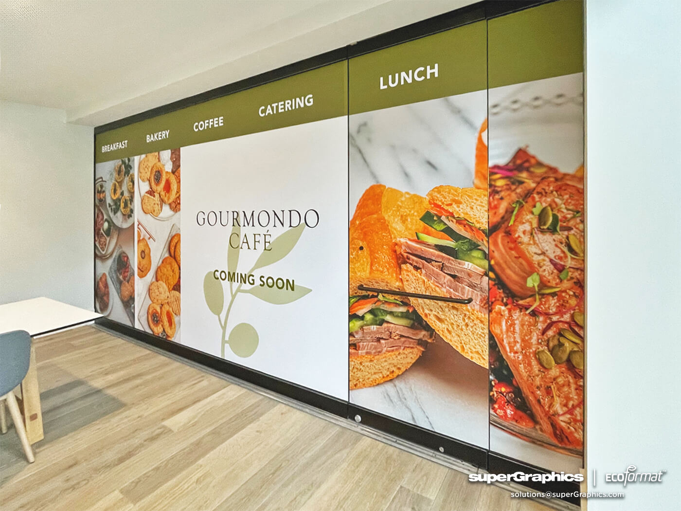 Indoor promotional graphics for Gourmondo Café's new location in Seattle.