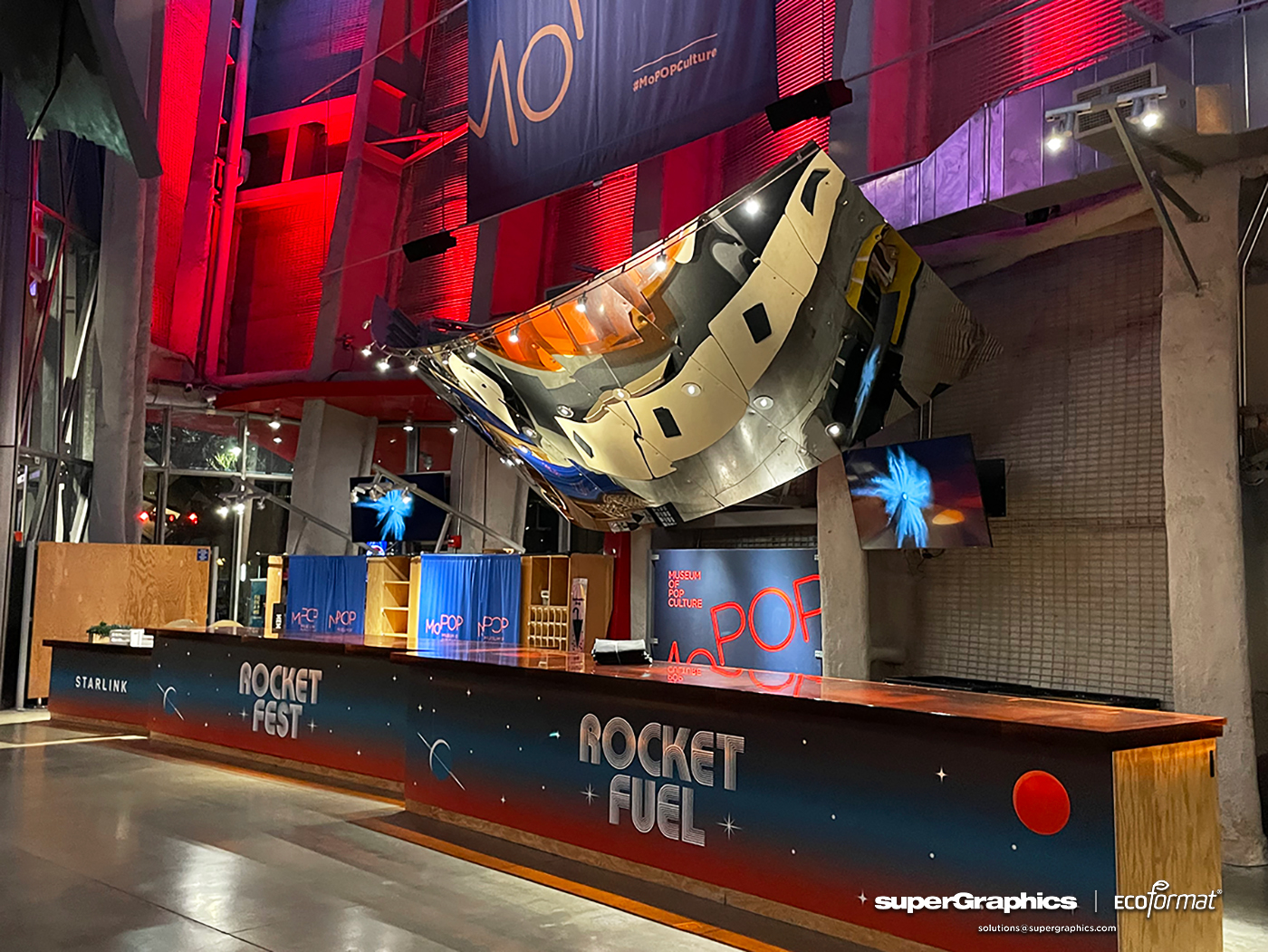 Reception area for SpaceX event with different bar wraps.