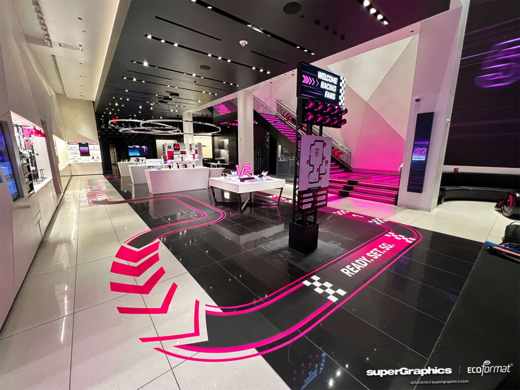 Vibrant floor graphics with racing themes enhance the customer journey in T-Mobile's flagship retail store.