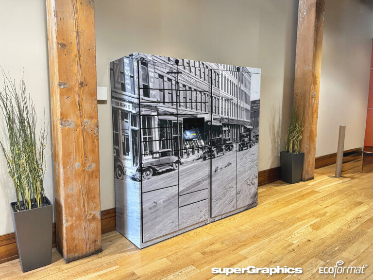 Vinyl-wrapped Luxer smart locker featuring a historical cityscape design with custom branding by SuperGraphics.