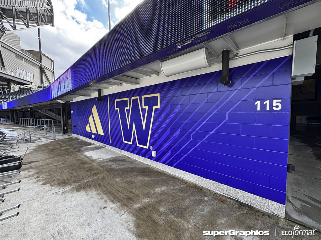 Large wall graphics featuring UW's logo in a football stadium.