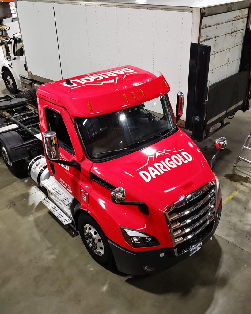 A Darigold semi-truck featuring a bold logo and red fleet wrap