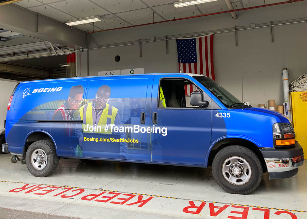 Boeing fleet wrap, produced and installed by SuperGraphics. Showcases branded graphics and photography of team, highlighting brand messaging "We're Team Boeing."