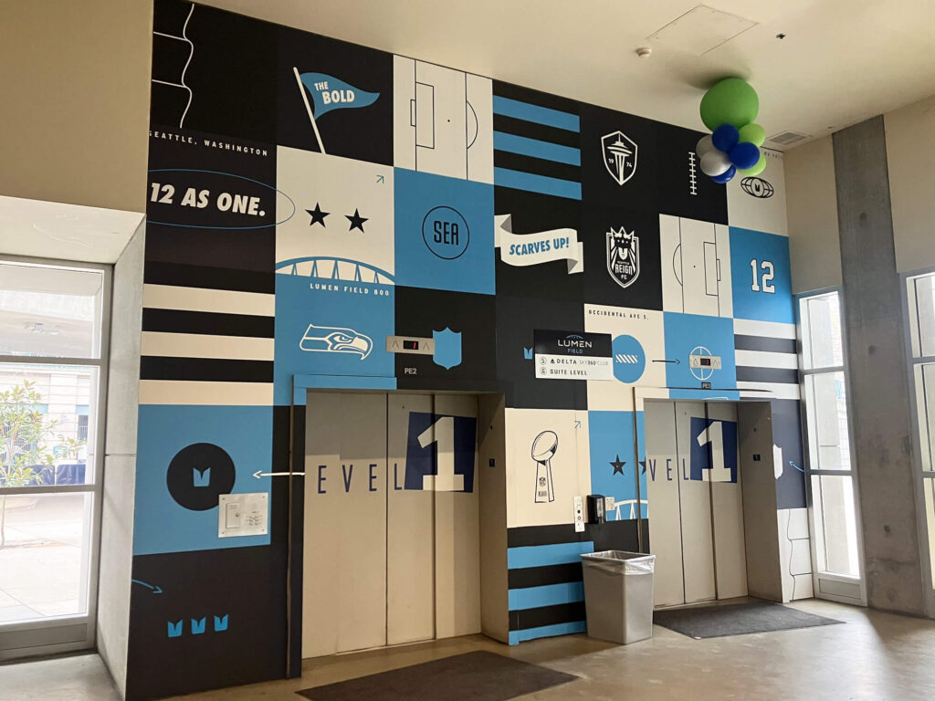 Lumen Field wall mural of various Seattle Sports teams and sports iconography, produced and installed by SuperGraphics.