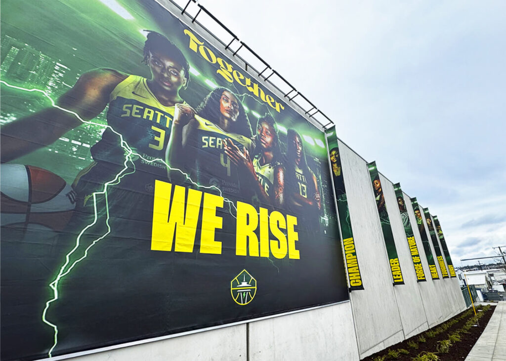 Seattle Storm Training Facility building banners, produced and installed by SuperGraphics. Features photos of various players and brand messaging.