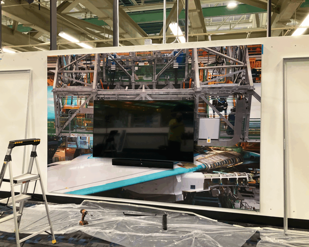 Photo of complex SEG Frame installation, produced and installed by SuperGraphics. Showcases wall-sized SEG Frame installed behind a TV.
