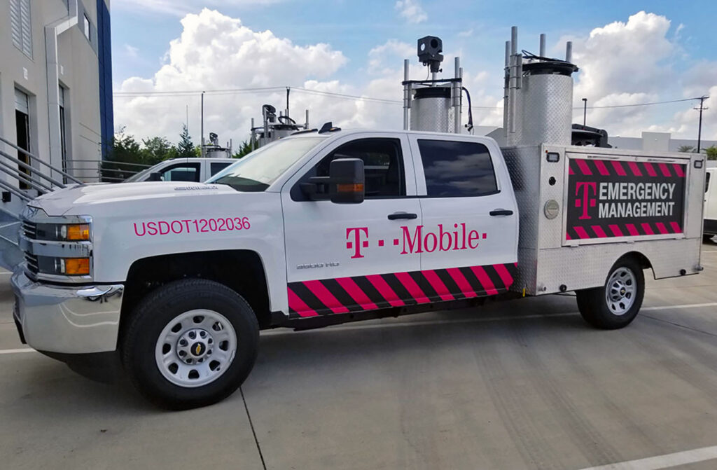 T-Mobile Disaster Recovery fleet truck with white and magenta vehicle graphics for Emergency Management and crisis communications.