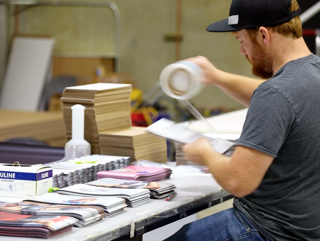 Photo of Imagine Visual Service Employee kitting retail graphics