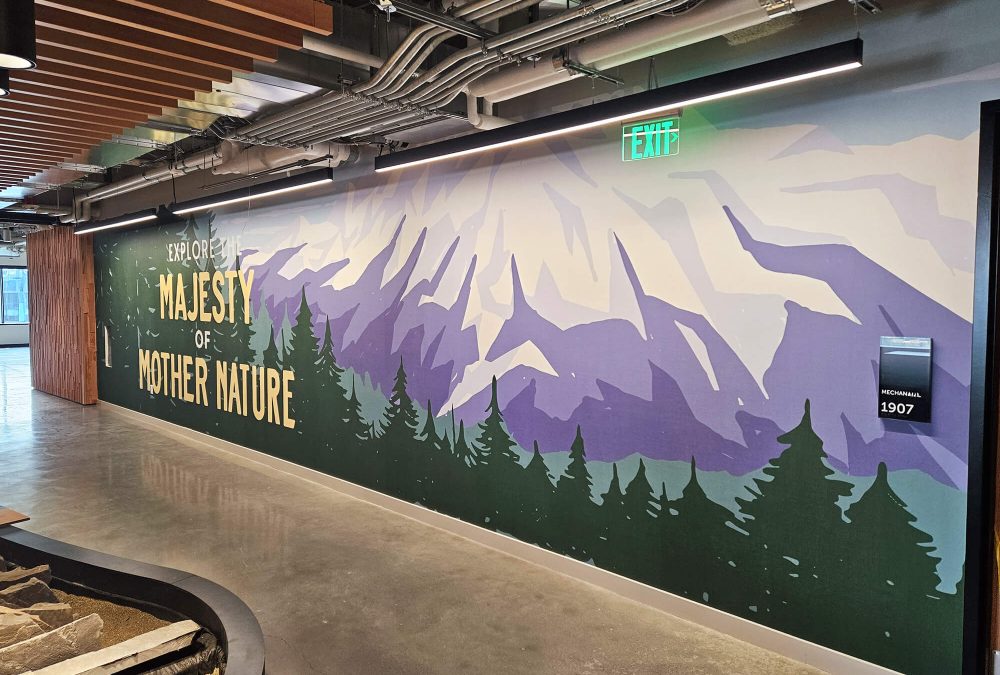 Corporate Office wall graphic produced and installed by SuperGraphics. Showcases mountain with text: Explore the Majesty of Mother Nature