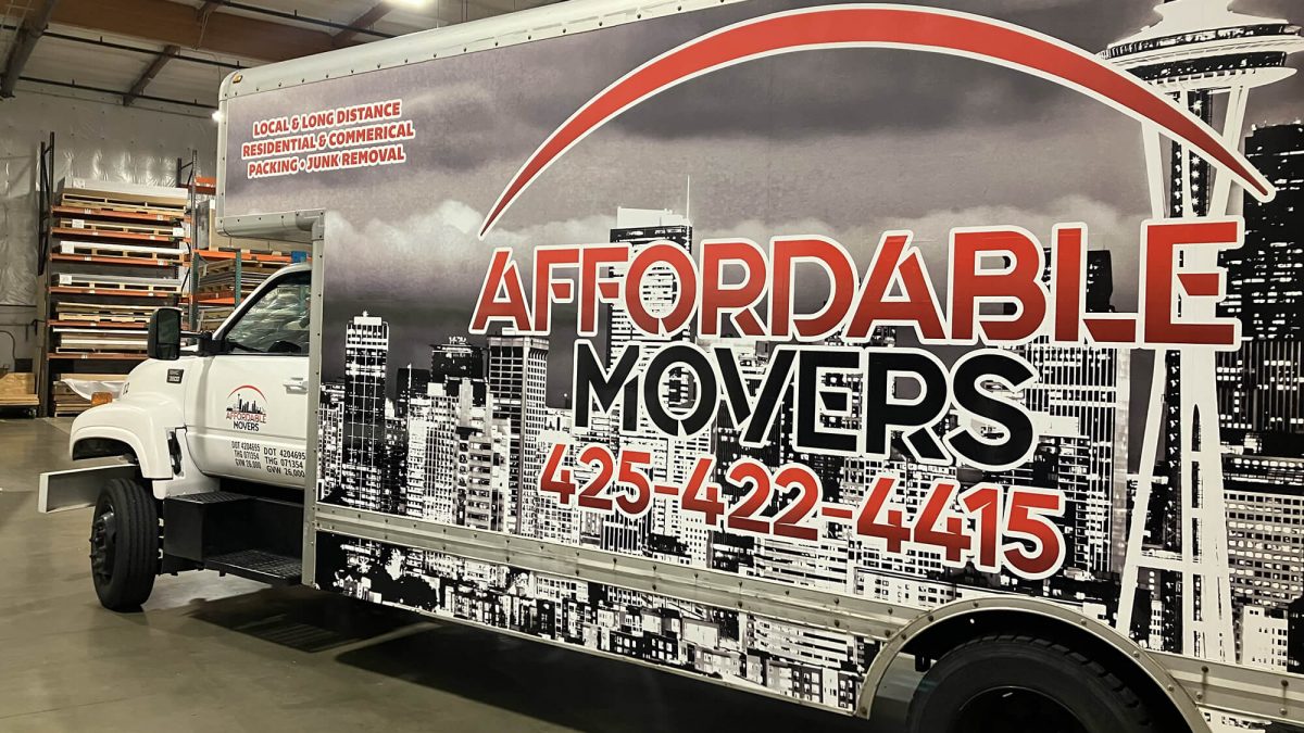 Affordable Movers fleet wrap, produced and installed by SuperGraphics. Showcases box truck with branded graphics and messaging in front of black-and-white cityscape.