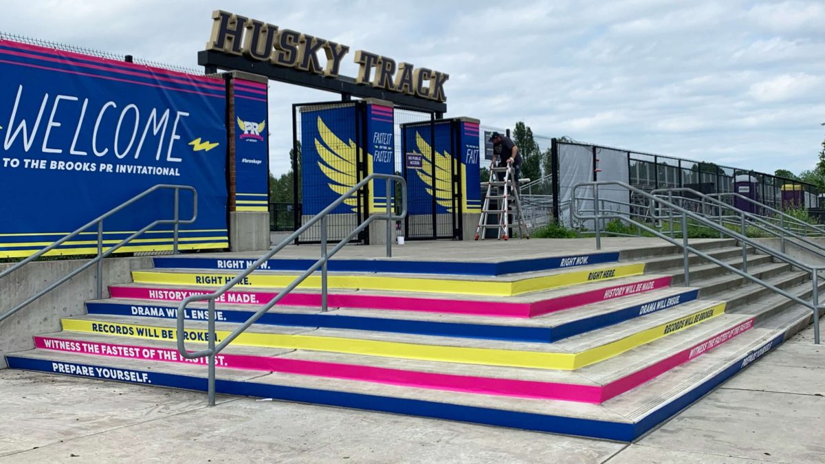 Stair riser graphics for Brooks' PR Invitational event, produced and installed by SuperGraphics. Showcases blue, pink, and yellow strips up a staircase with motivational messaging.
