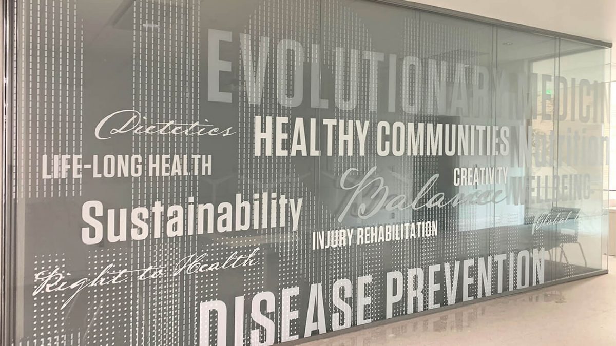 Central Washington University Health Services Window Graphics, produced and installed by SuperGraphics. Showcases health-sciences related words in various fonts on white vinyl. Serving as privacy film on glass walls.