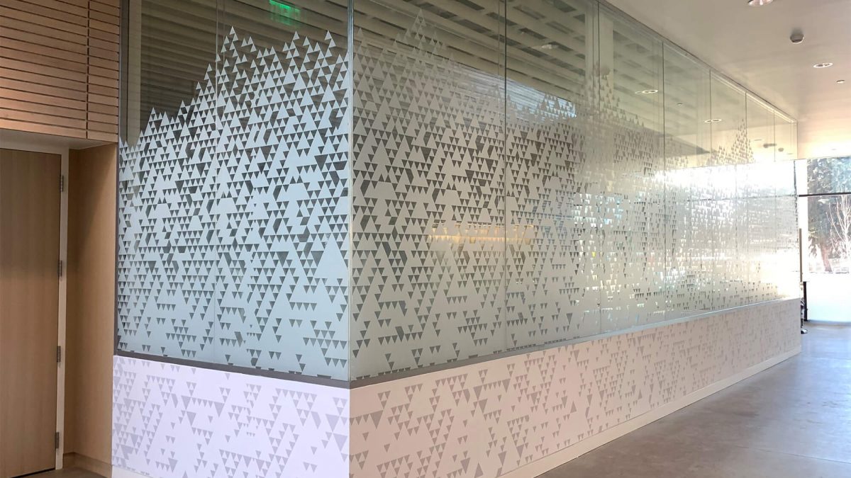 Central Washington University Health Services Window Graphics, produced and installed by SuperGraphics. Showcases triangular pattern on white vinyl, serving as privacy film on glass walls.