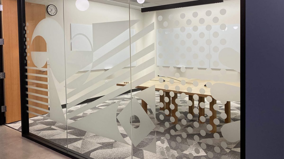 Corporate Privacy Window film, produced and installed by SuperGraphics. Showcases custom designs on dusted crystal window film, on corporate office glass wall.
