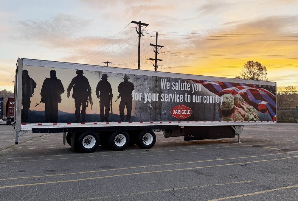 Darigold Fleet Wrap, produced and installed by SuperGraphics. Showcases Darigold branding and messaging in front of American patriotic photography. Messaging says "We salute you for your service to our country."