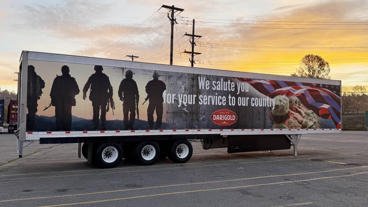 Darigold Fleet Wrap, produced and installed by SuperGraphics. Showcases Darigold branding and messaging in front of American patriotic photography. Messaging says "We salute you for your service to our country."