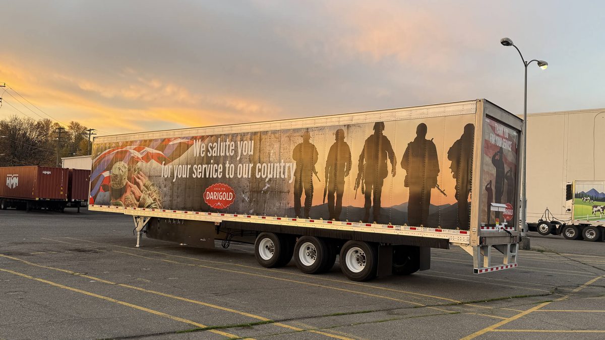 Darigold Fleet Wrap, produced and installed by SuperGraphics. Showcases Darigold branding and messaging in front of American patriotic photography. Messaging says "We salute you for your service to our country."