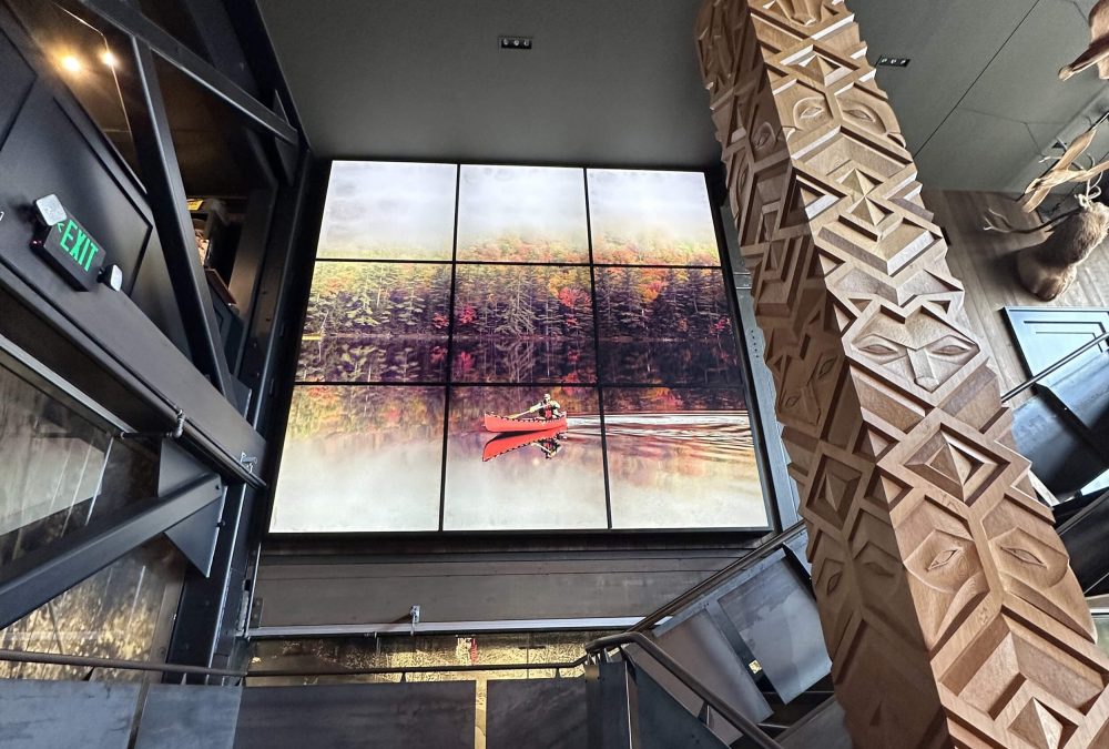 Multi-panel backlit SEG fabric display featuring a red canoe on an autumn lake installed in the Filson flagship store stairwell produced by SuperGraphics