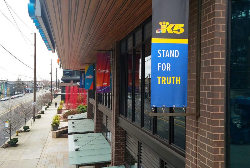 King 5 Media Group Hanging Banners at the King 5 Broadcasting Station. Features banners for King 5 News, Evening, New Day Northwest, and King 5 Investigators.