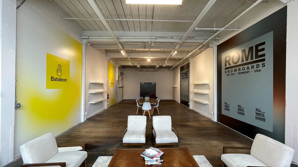 Wide view of a modern office interior with vibrant Bataleon and Rome Snowboards wall murals