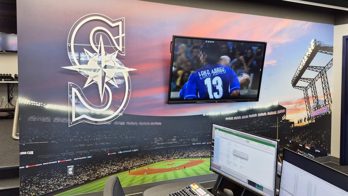 Seattle Mariners corporate office wall graphic, produced and installed by SuperGraphics. Showcases wall mural of stadium and dimensional signage of logo.