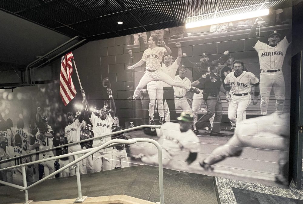 Wall mural for Seattle Mariners Training Facility, showcasing black and white collage of players on field. Produced and installed by SuperGraphics.