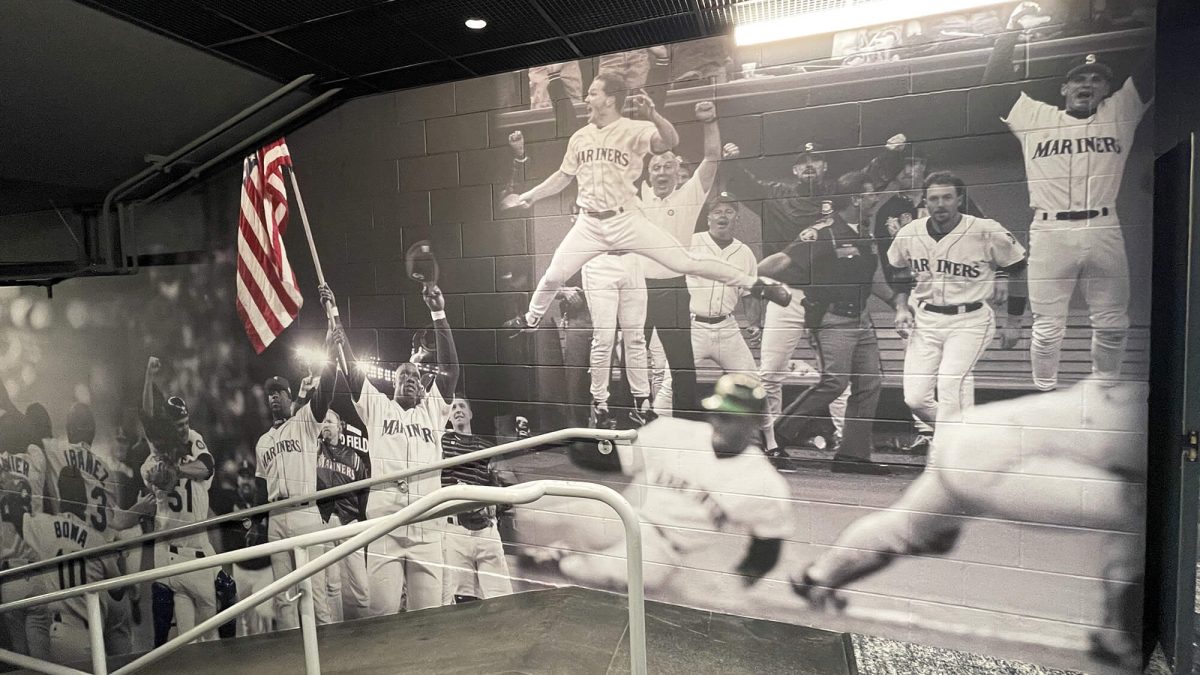 Wall mural for Seattle Mariners Training Facility, showcasing black and white collage of players on field. Produced and installed by SuperGraphics.