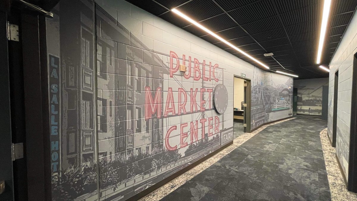 Wall mural for Seattle Mariners Training Facility, showcasing Seattle cityscape and Pike Place Market. Produced and installed by SuperGraphics.