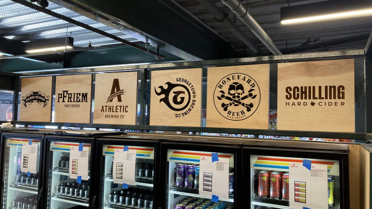 Seattle Mariners Walk off Market Signage, produced and installed by SuperGraphics. Showcases wood paneling and vinyl lettering of products.