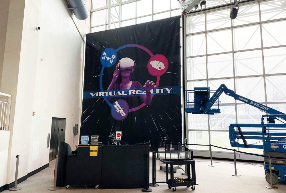 Large-scale Virtual Reality banner installation inside the Museum of Flight, showcasing immersive exhibit graphics printed and installed by SuperGraphics.