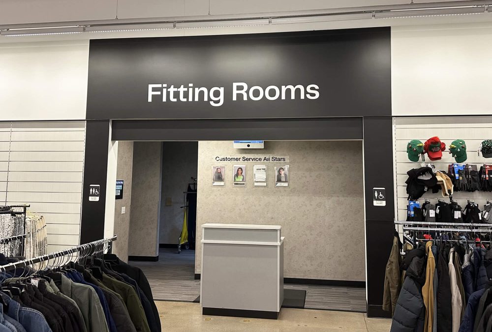 Nordstrom Rack wall mural, produced and installed by SuperGraphics. Graphic says 'Fitting Rooms' over entryway.