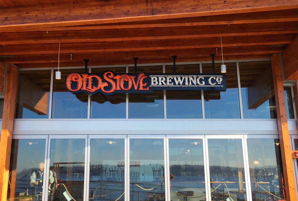 Old stove neon signage, produced and installed by SuperGraphics. Features Old Stove logo in neon red and white letters.