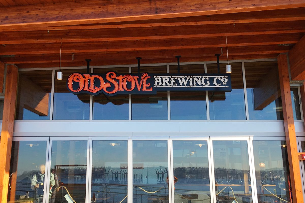 Old stove neon signage, produced and installed by SuperGraphics. Features Old Stove logo in neon red and white letters.