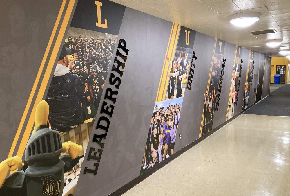 Pacific Lutheran University Athletics Wall Graphics, produced and installed by SuperGraphics. Showcases design of various student athletes along dimensional lettering of brand messaging.