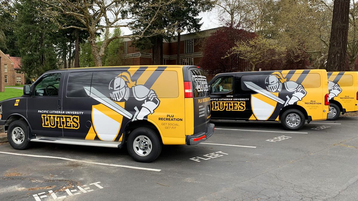 Pacific Lutheran University's service vehicle fleet wrap, produced and installed by SuperGraphics. Showcases brand logos and PLU mascot atop black and white graphics.