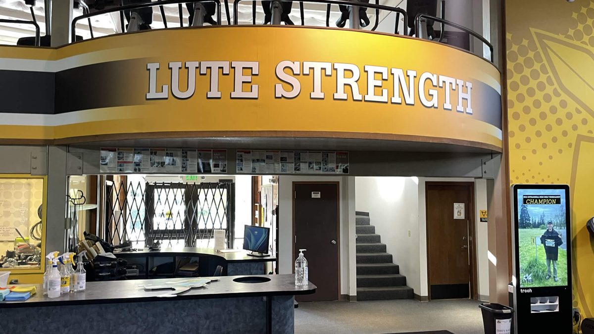 Pacific Lutheran University gym graphics, produced and installed by SuperGraphics. Showcases yellow wall murals and brand messaging: "Lute Strength."