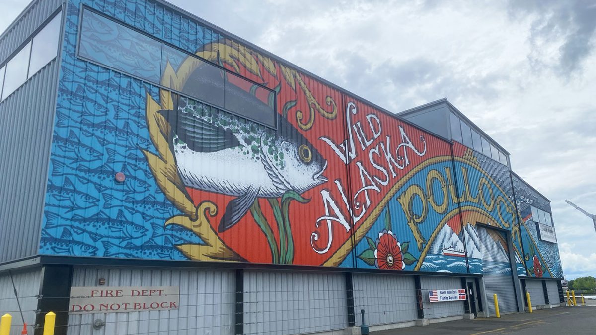 Building Wrap at Pier 91. Features artwork for the Genuine Alaska Pollock Producers by Kyler Martz. Graphics produced and installed by SuperGraphics.