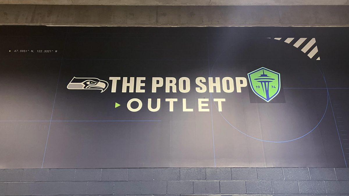 The Pro Shop Outlet wall mural, produced and installed by SuperGraphics. Includes the company name and Seattle sports logos on a blue background.