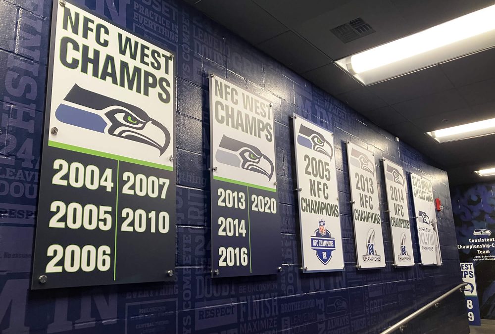 Seattle Seahawks facility signage, produced and installed by SuperGraphics. Signage states organization wins over the years.