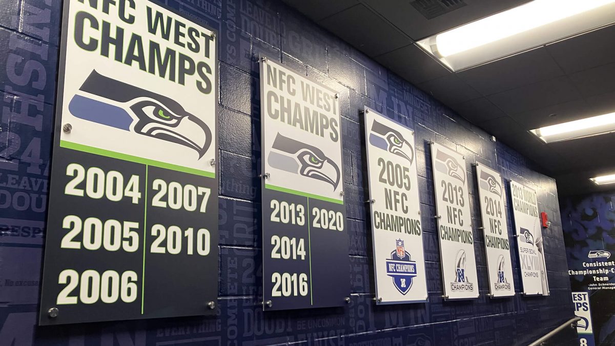 Seattle Seahawks facility signage, produced and installed by SuperGraphics. Signage states organization wins over the years.