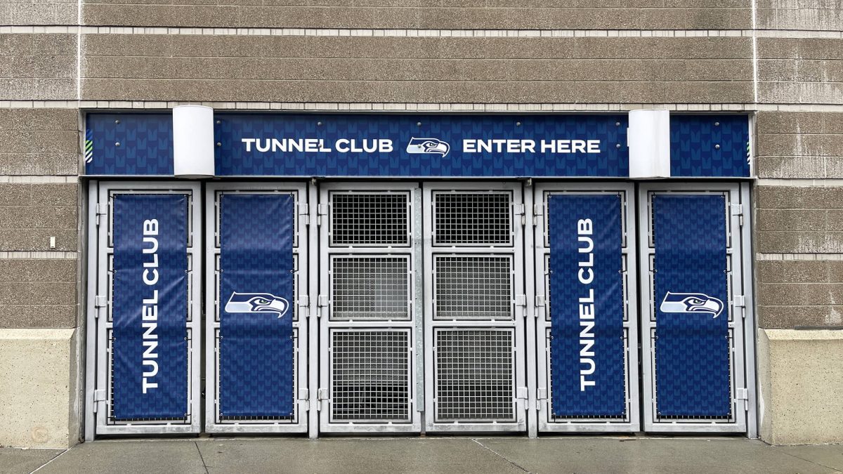Seattle Seahawks Tunnel Club entrance, produced and installed by SuperGraphics. Showcases wayfinding and entryway signage.