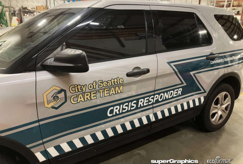 Angled side view of a white Seattle CARE Team SUV