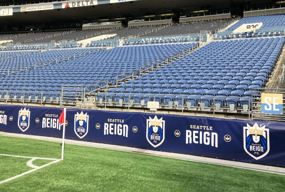 Seattle Reign field banners, produced and installed by SuperGraphics. Showcases Seattle Reign iconography and logos in front of stadium seats.