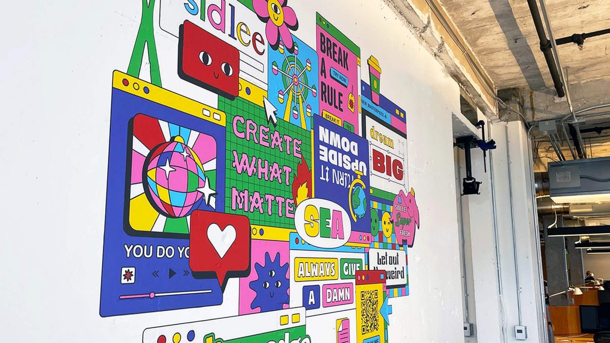 Wall graphic for Sid Lee corporate office, produced and installed by SuperGraphics. Showcases colorful branded illustrations woven into various Sid Lee brand messaging.