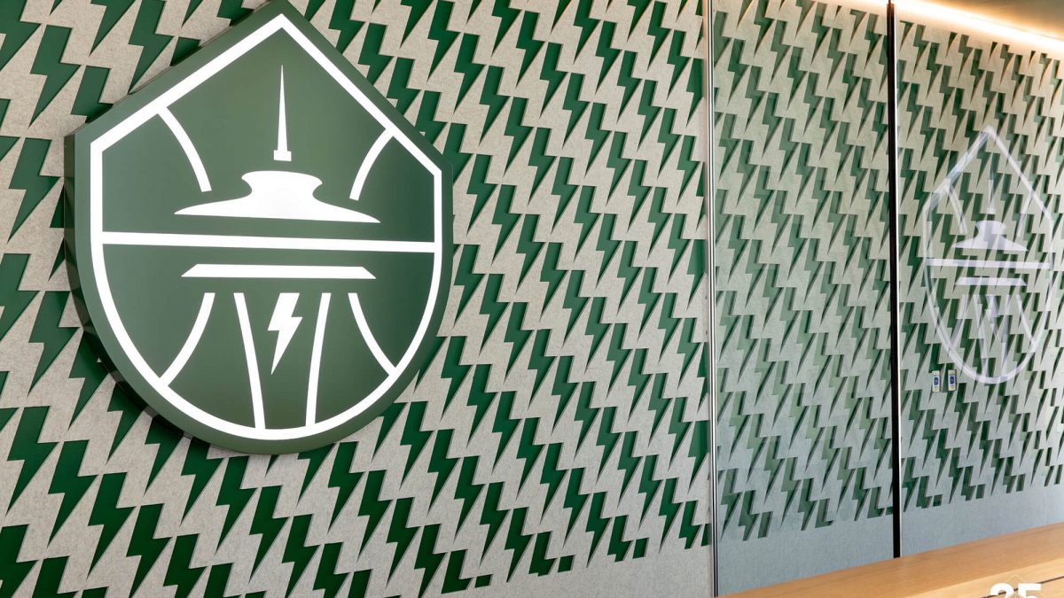 Seattle Storm Training Facility wall mural and signage, produced and installed by SuperGraphics. Signage showcases storm logo and wall mural features lightning bolt iconography.