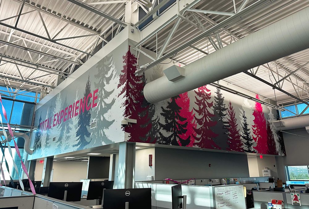 T-Mobile corporate office wall graphic, produced and installed by SuperGraphics. Showcases evergreen trees in brand colors on high office wall.