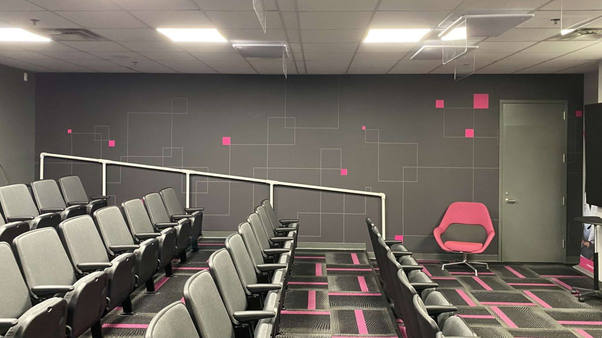 Corporate office wall graphic, produced and installed by SuperGraphics. Showcases T-Mobile's pink branding in an auditorium office space.