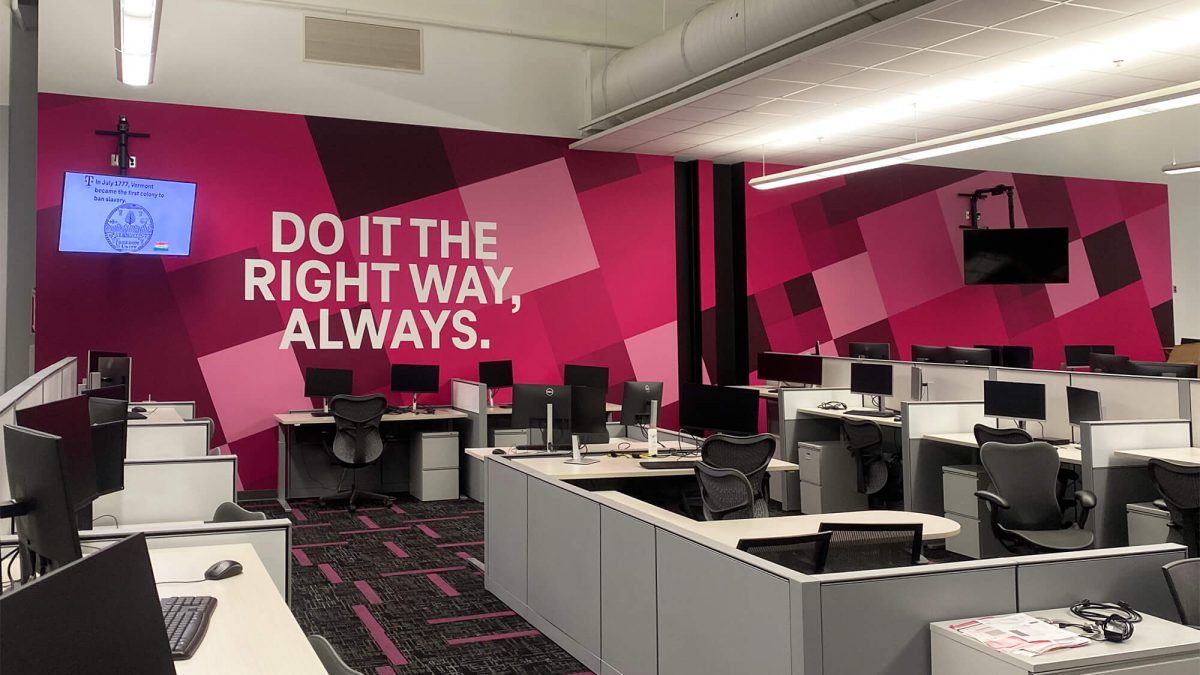 Corporate office wall graphic, produced and installed by SuperGraphics. Showcases T-Mobile's pink branding design in a corporate office cubicle space. Message says, "Do the right thing, always"